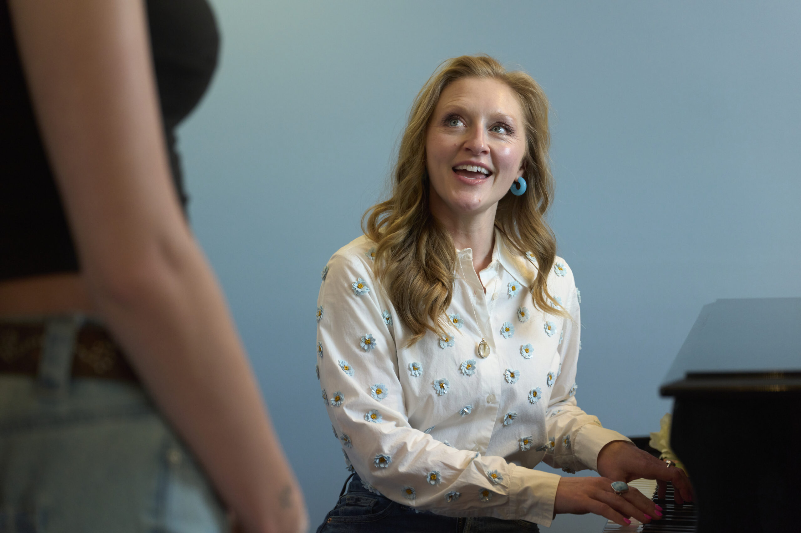 Sarah Hawkey Soprano Voice Teacher Laughing in a singing lesson in her voice studio in Fairfield County, CT